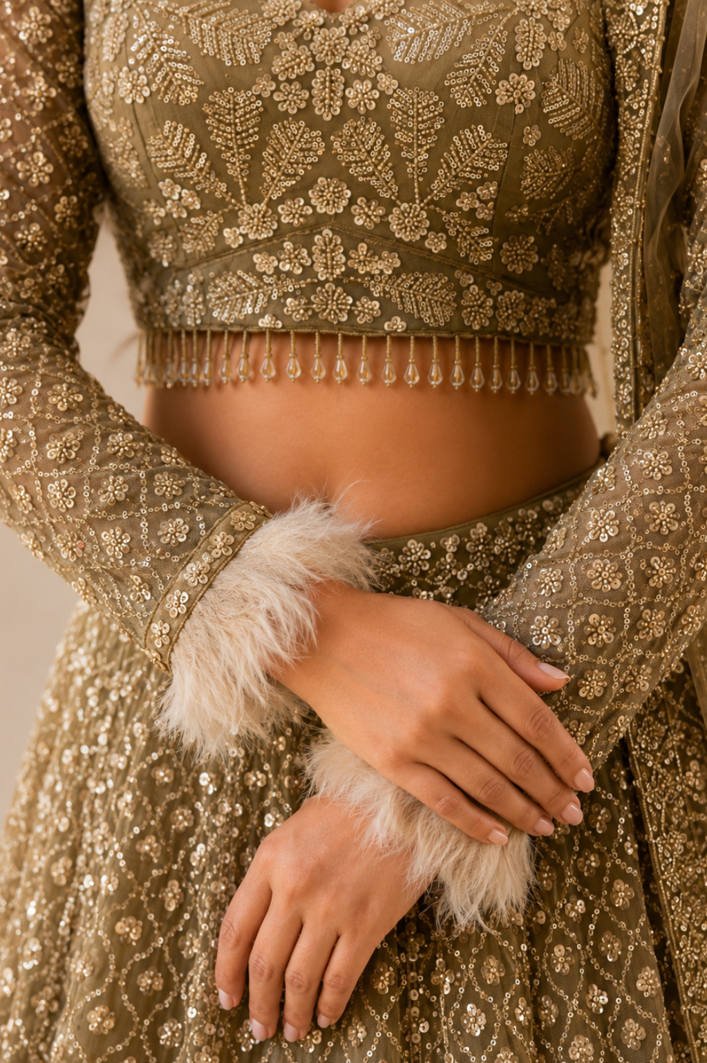 Beige Net Bridal Lehenga with Sequin Cutdana Work Model wearing beige bridal net lehenga with sequin cutdana embroidery, styled with matching dupatta and earrings