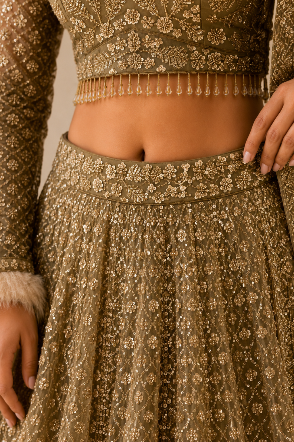 Beige Net Bridal Lehenga with Sequin Cutdana Work Detailed view of embroidered waistband and sequin cutdana work on beige bridal lehenga skirt
