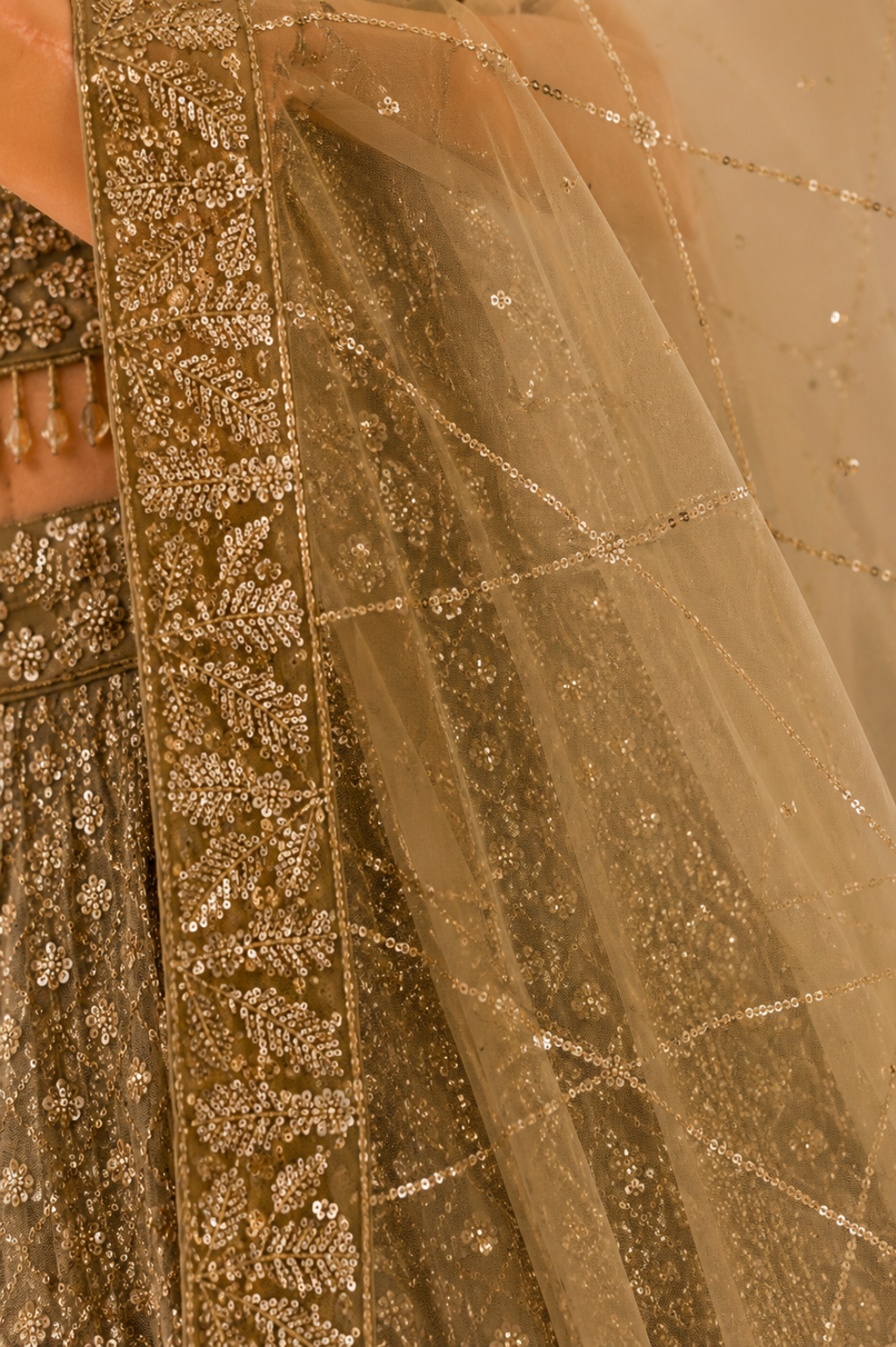 Beige Net Bridal Lehenga with Sequin Cutdana Work Bridal net dupatta close-up featuring embroidered border with delicate sequin cutdana detailing in beige