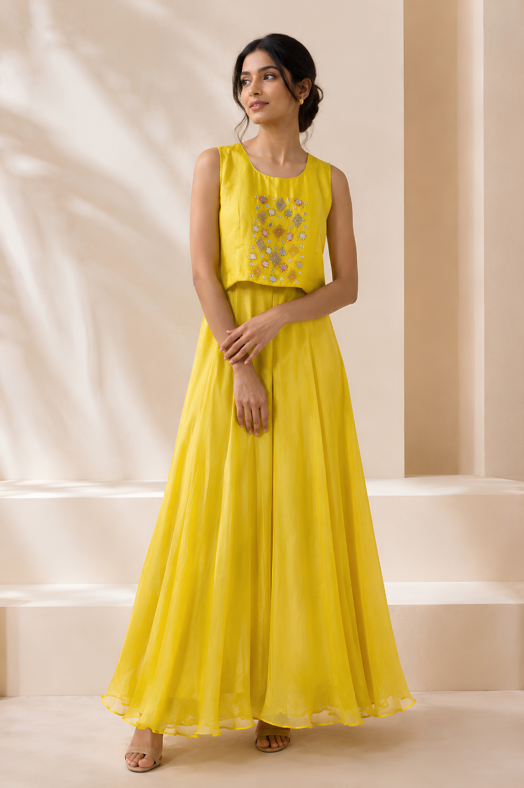 Yellow Shrug Set in Chinon Crepe with Mirror & Thread Work Sleeveless yellow Chinon Crepe dress with mirror embroidery from the Mansa Sarees shrug set